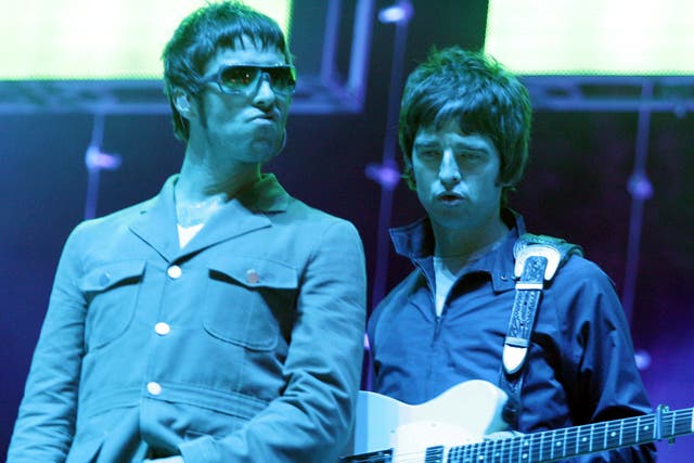 Liam and Noel Gallagher performing together with Oasis in 2005