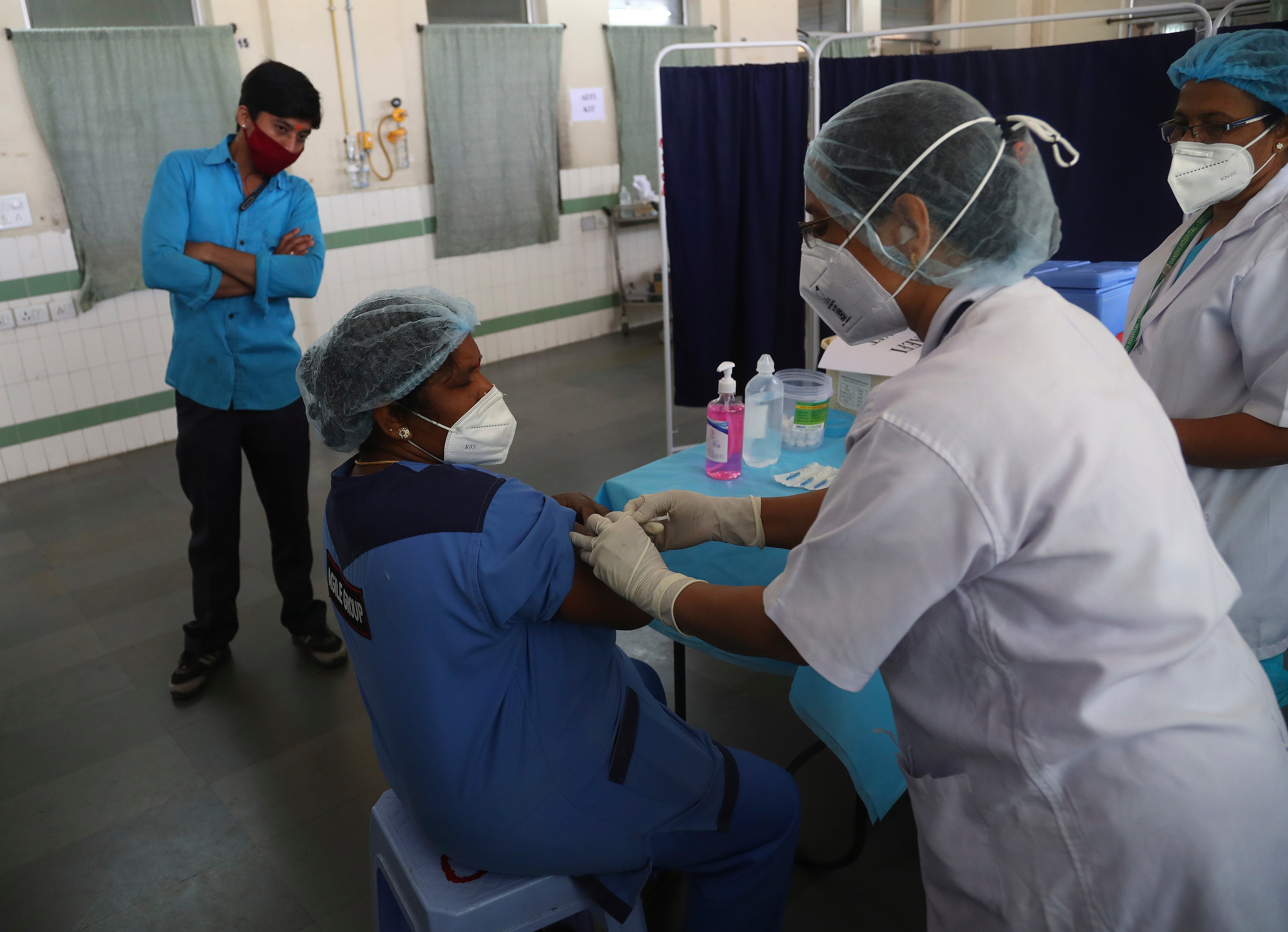 Health workers participate in a COVID-19 vaccine delivery system trial in Hyderabad, India, Saturday, Jan. 2, 2021