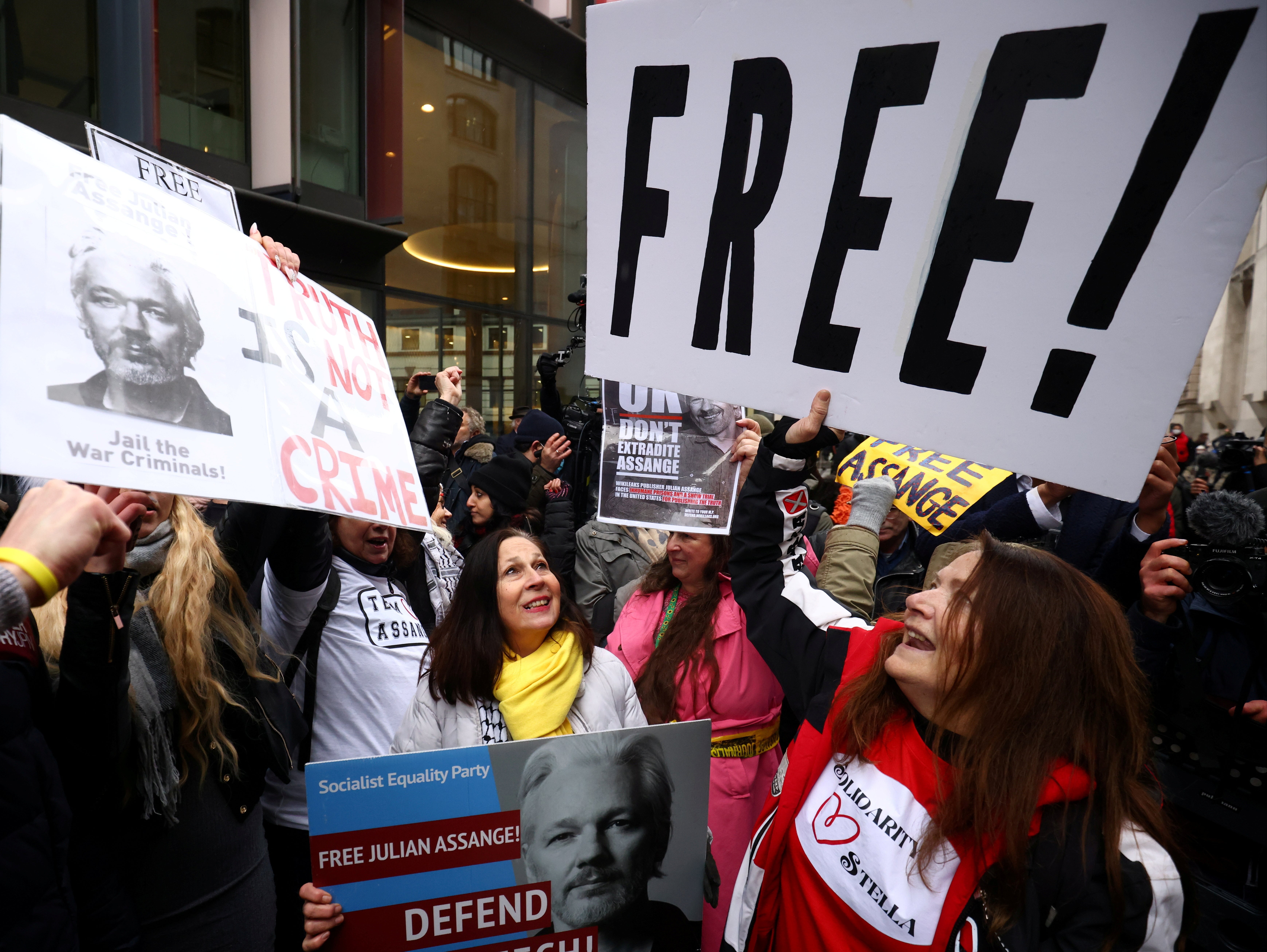 People celebrate after a judge ruled that WikiLeaks founder Julian Assange should not be extradited to the United States, outside the Old Bailey in London, Britain, January 4, 2021.