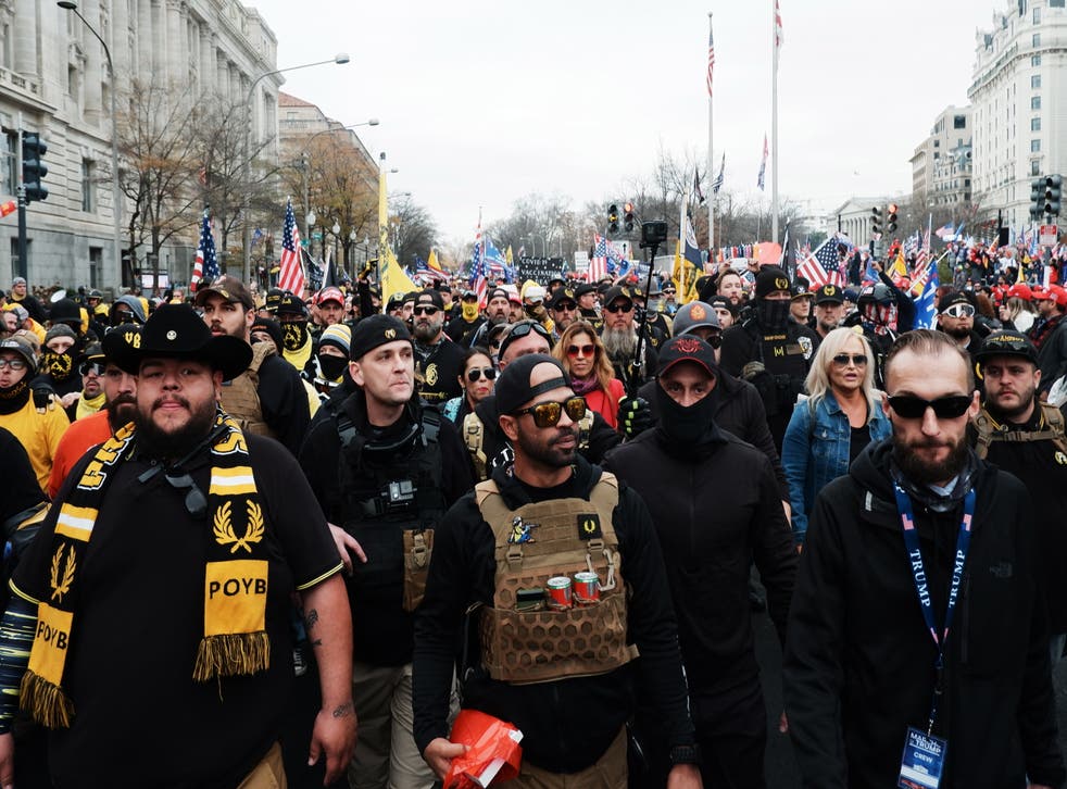 <p>Enrique Tarrio, centre, and members of the far-right Proud Boys led demonstrations in Washington DC on 12 December.</p>