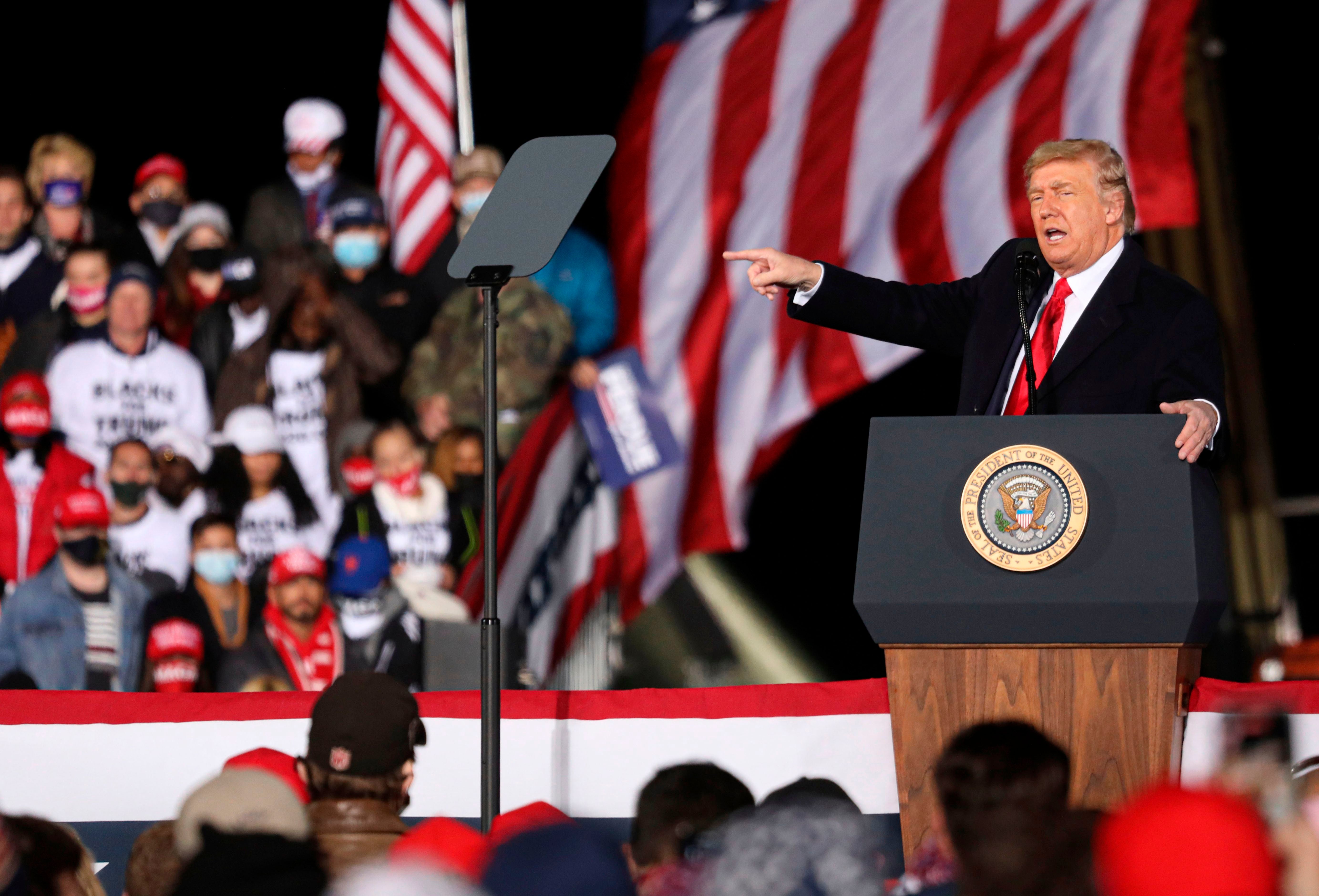 US President Donald Trump gestures as he speaks during a rally in support of Republican incumbent senators Kelly Loeffler and David Perdue ahead of Senate runoff in Dalton, Georgia on January 4, 2021.