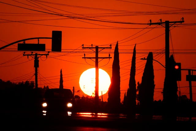 The sun sets behind power lines in Los Angeles, California during a heatwave in September. Cities around the world are projected to experience a drop in humidity by the end of the century due to the climate crisis
