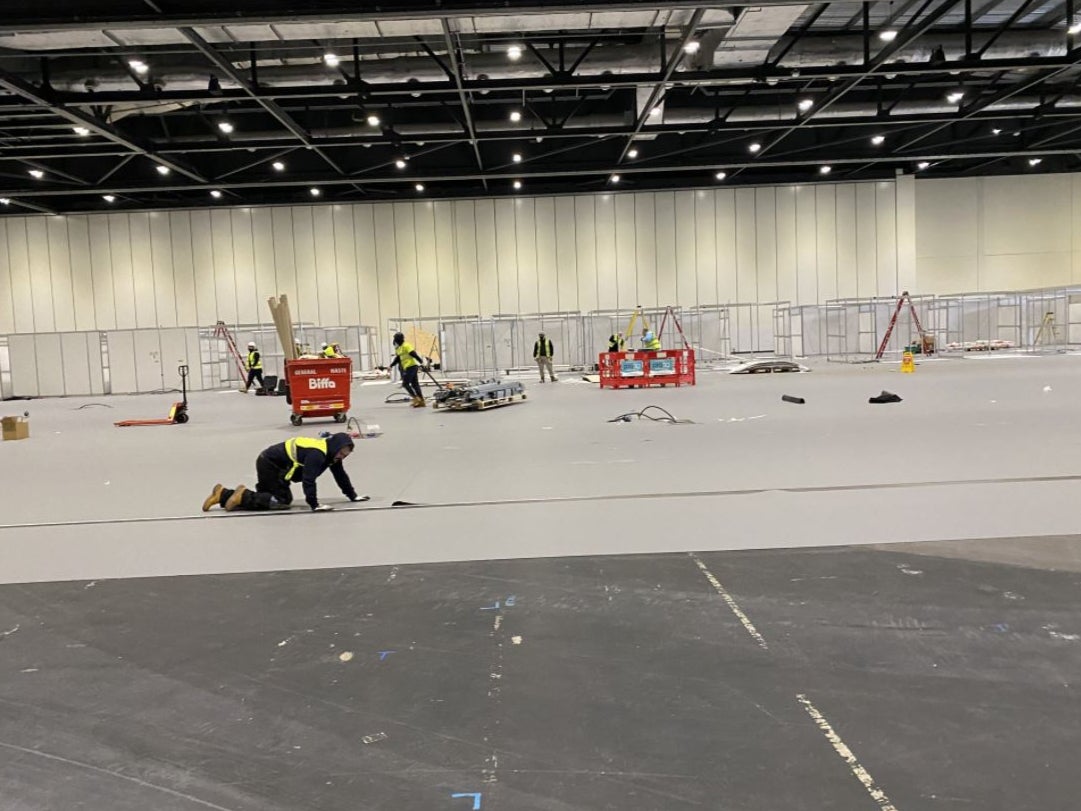 Workmen prepare the NHS Nightingale hospital at the ExCel Centre in east London