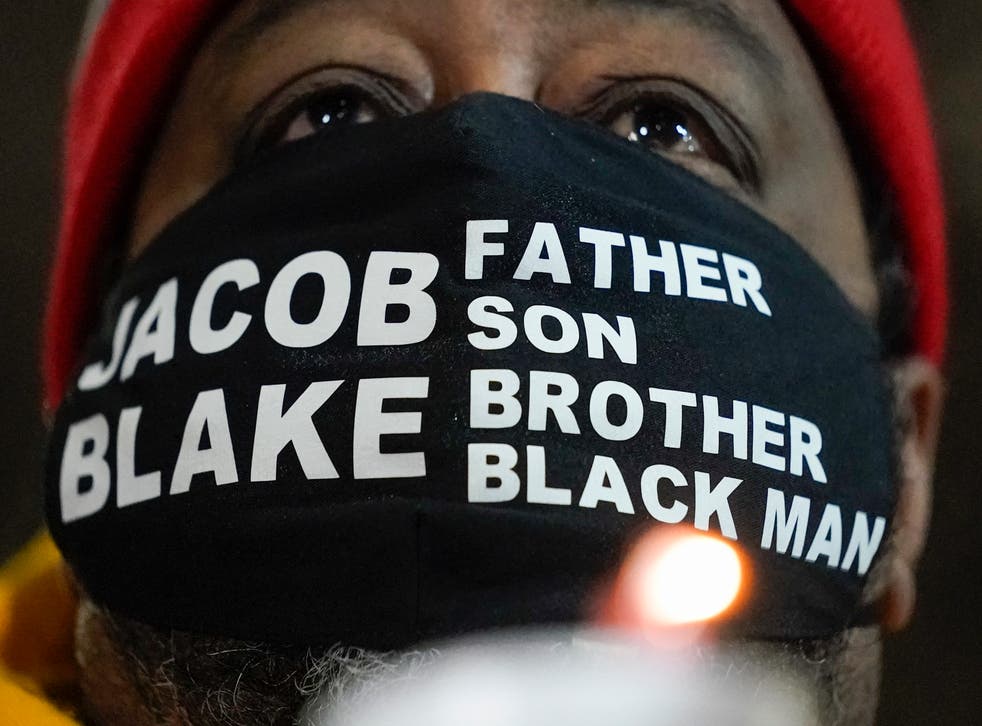 Jacob Blake Sr, father of Jacob Blake, holds a candle at a rally on Monday, 4 January 2021, in Kenosha, Wisconsin