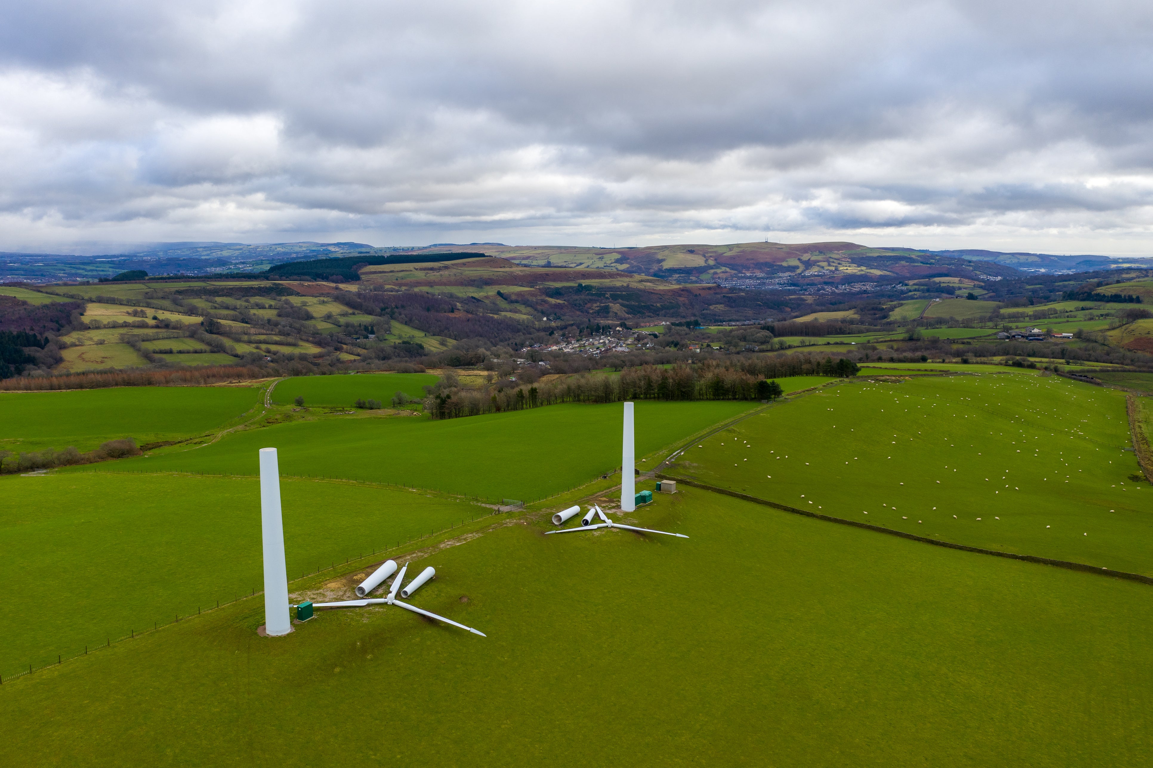 Aerial view of a wind turbine being constructed from pieces in Rhondda, Wales