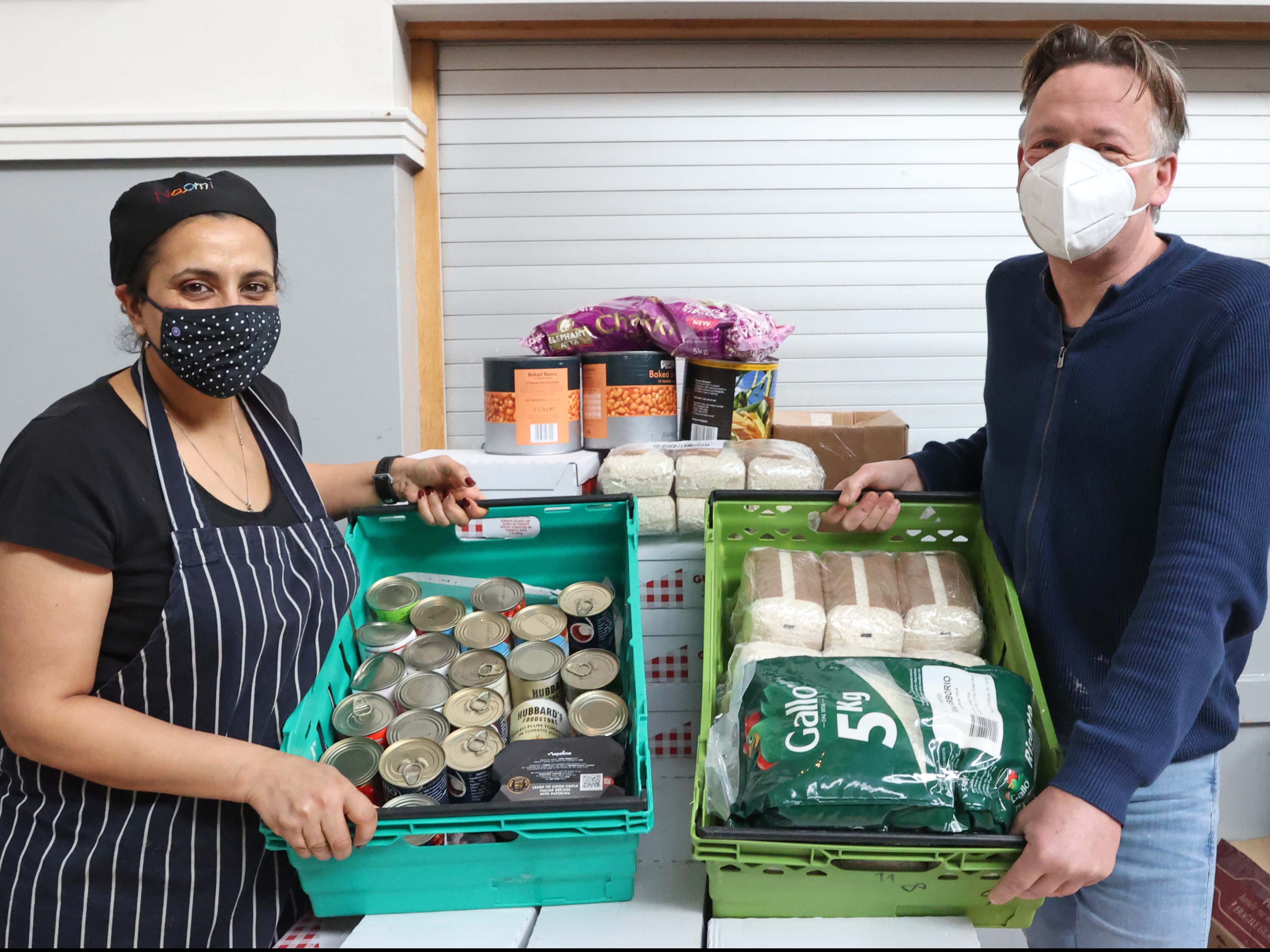 Volunteer Naomi Clucas in the kitchen and food preparation area at Scottish House with Leon Aarts