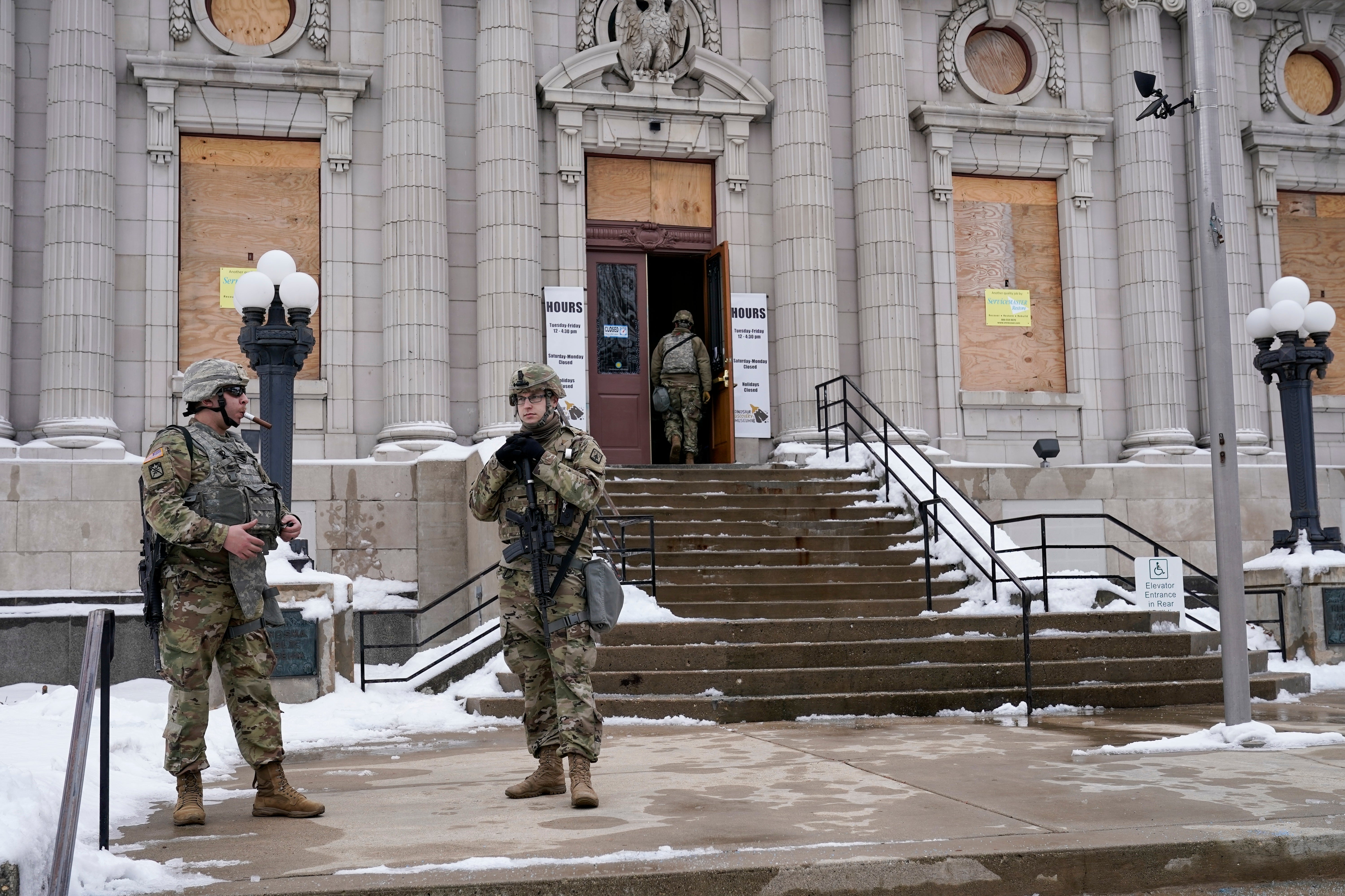 National guard members stage outside a museum as an announcement is expected on whether any police officers will be charged in the August 2020 shooting of Jacob Blake