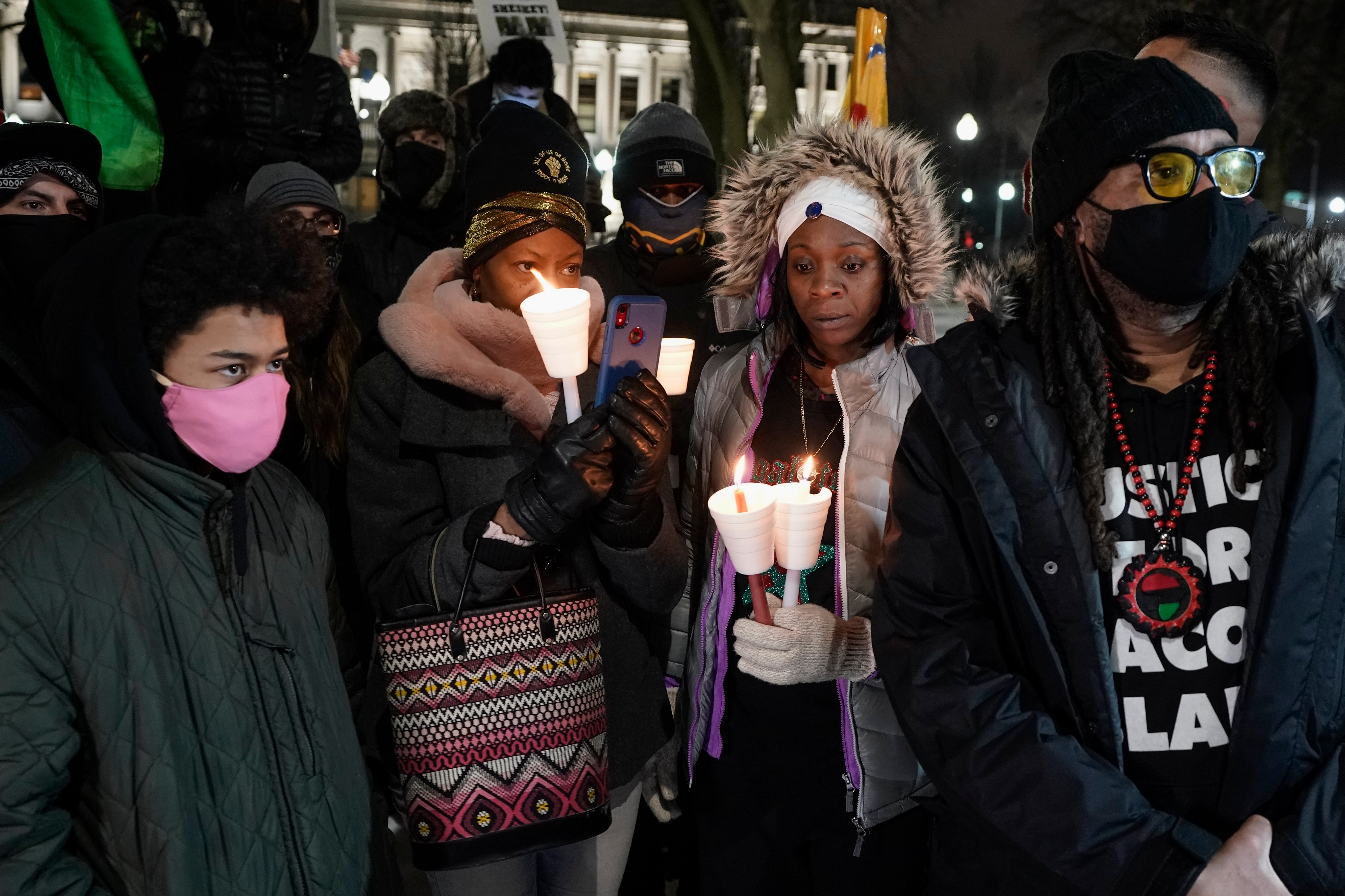 Supporters hold candles at a rally for Jacob Blake who has been paralysed since being shot by police office Rusten Sheskey in August