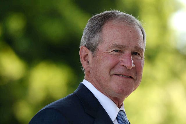 <p>George W Bush looks on upon</p>