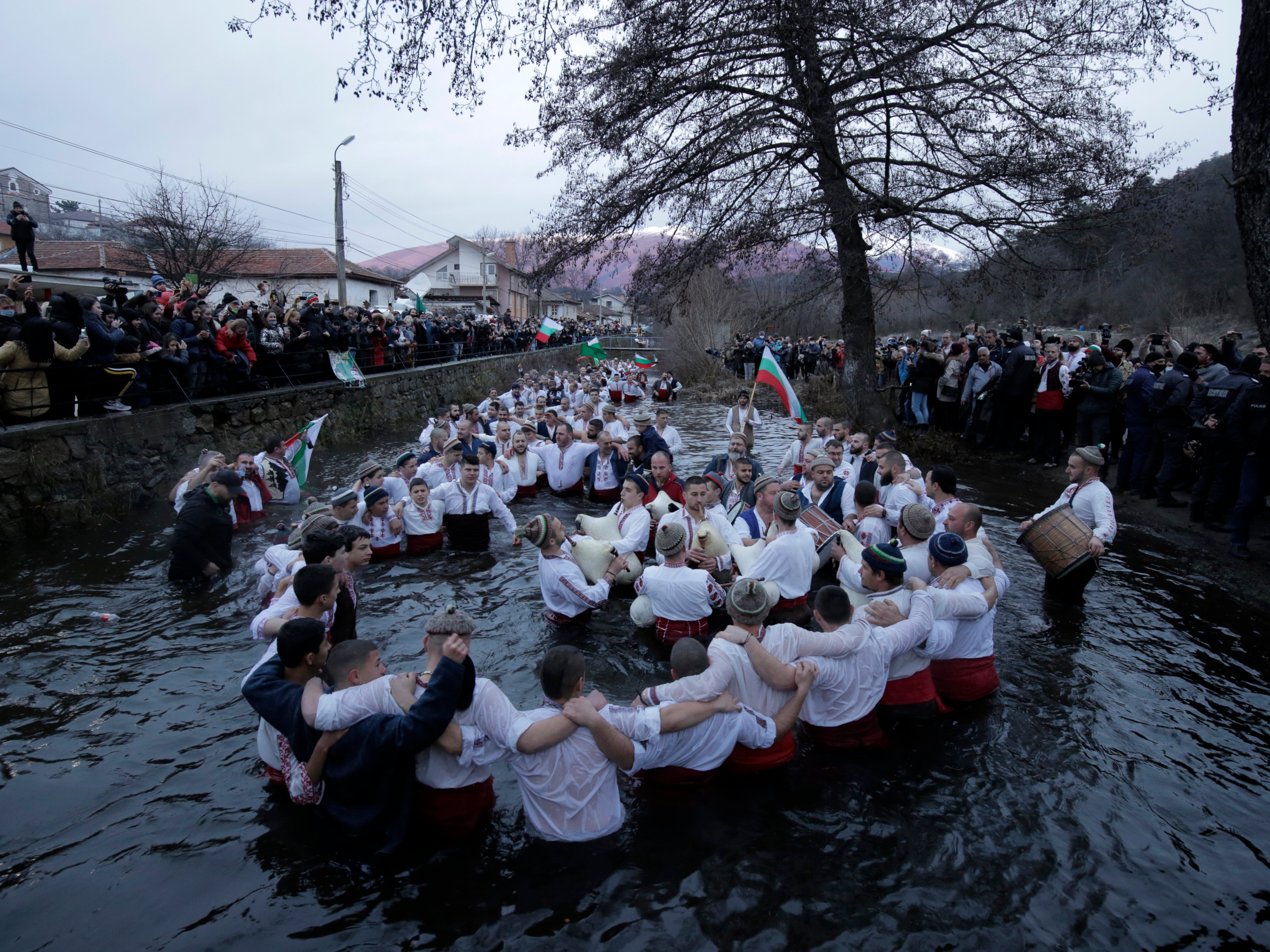 Kalofer citizens stand in the icy Tundzha River ready to recover a crucifix cast by a priest in an old ritual marking the feast of Epiphany