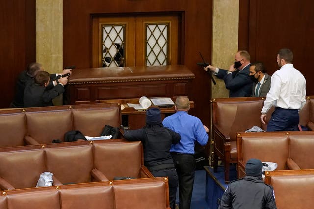 <p>Security officers hold rioters at bay inside the House chamber.</p>