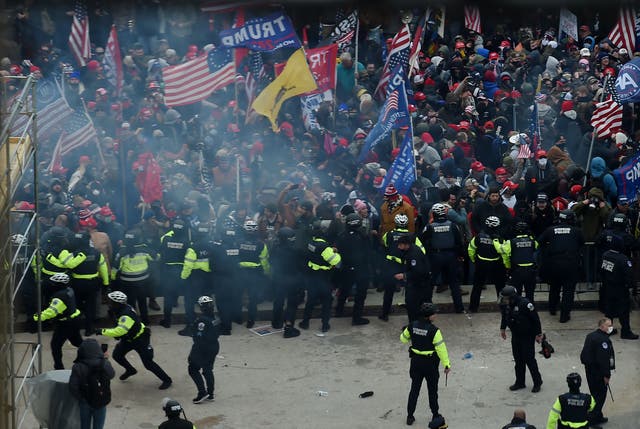 Police hold back Trump supporters as they gather outside the US Capitol’s Rotunda