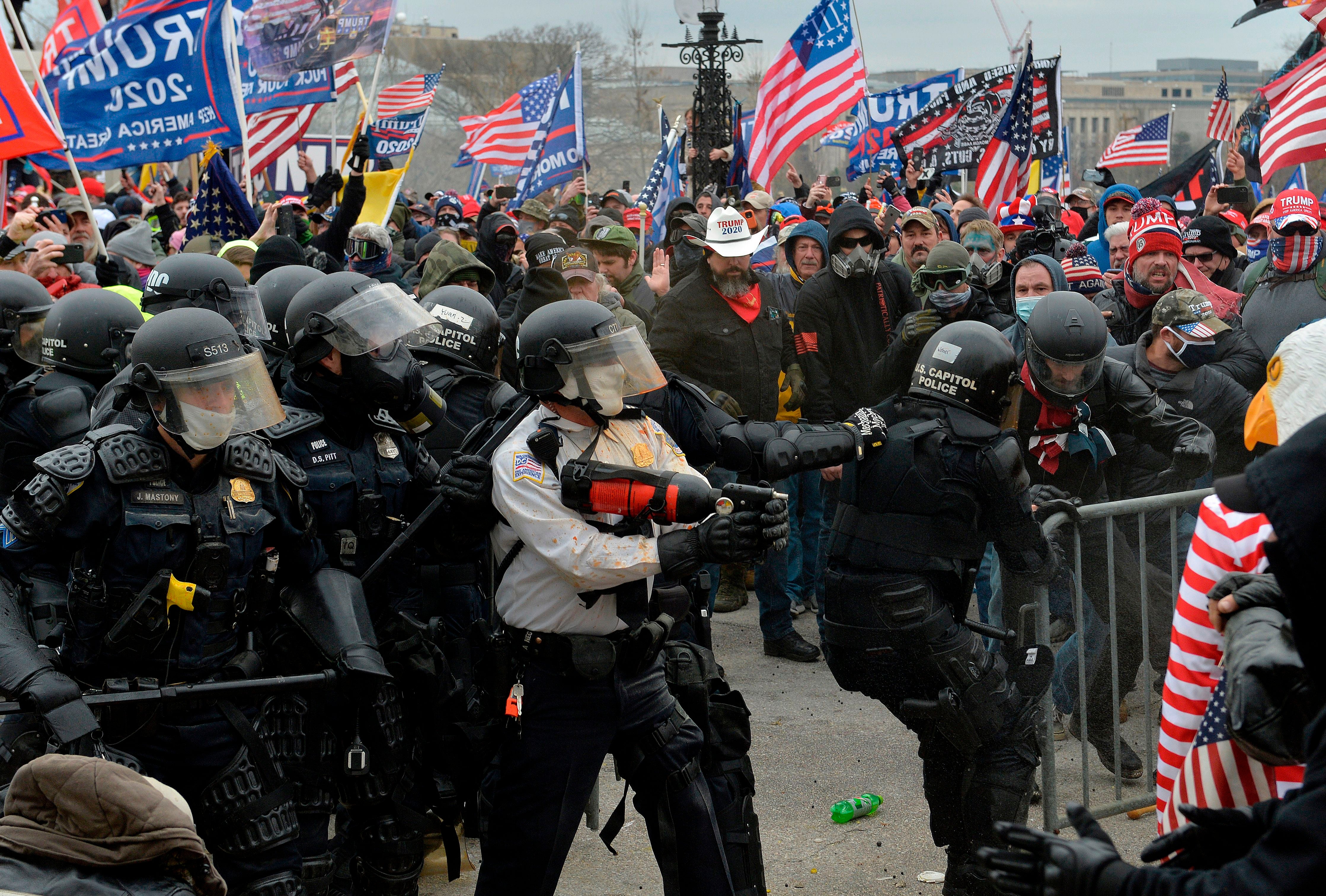 <p>Pro-Donald Trump rioters clash with police outside the US Capitol building, which some of them stormed after breaking windows and overrunning police. One woman died.</p>