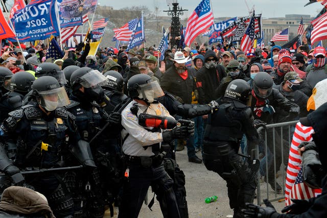<p>Pro-Donald Trump rioters clash with police outside the US Capitol building, which some of them stormed after breaking windows and overrunning police. One woman died.</p>