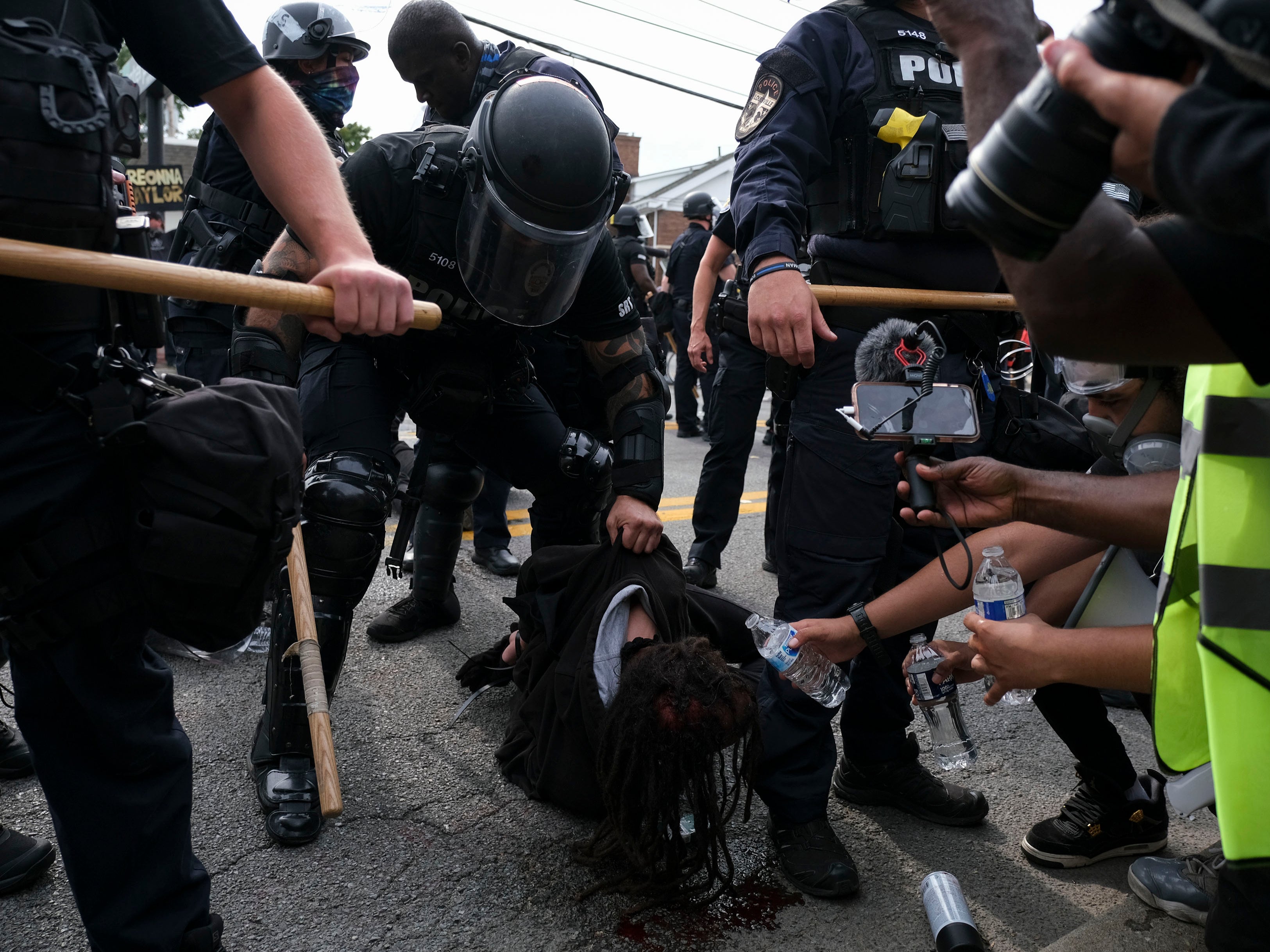 A BLM protestor is detained while bleeding from the head in downtown Louisville, on September 23, 2020