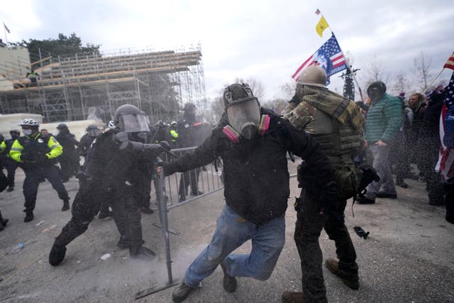 <p>Rioters break through a police barrier at the Capitol on 6 January.</p>