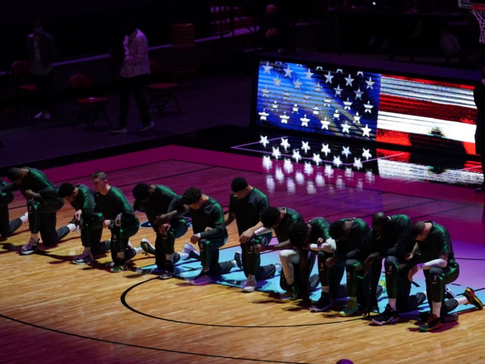 Players from the Boston Celtics kneel for the national anthem