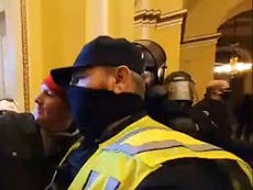Police officer filmed posing for selfie with pro-Trump rioter