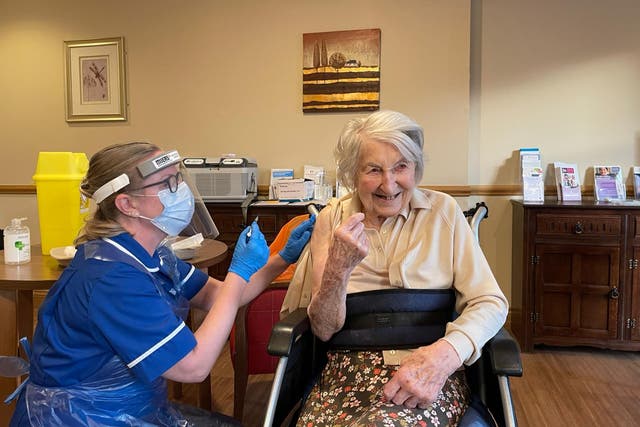 Handout photo of 104-year-old Joyce Birrell receiving the Pfizer/BioNtech covid-19 vaccine at Foxholes Care Home in Hertfordshire