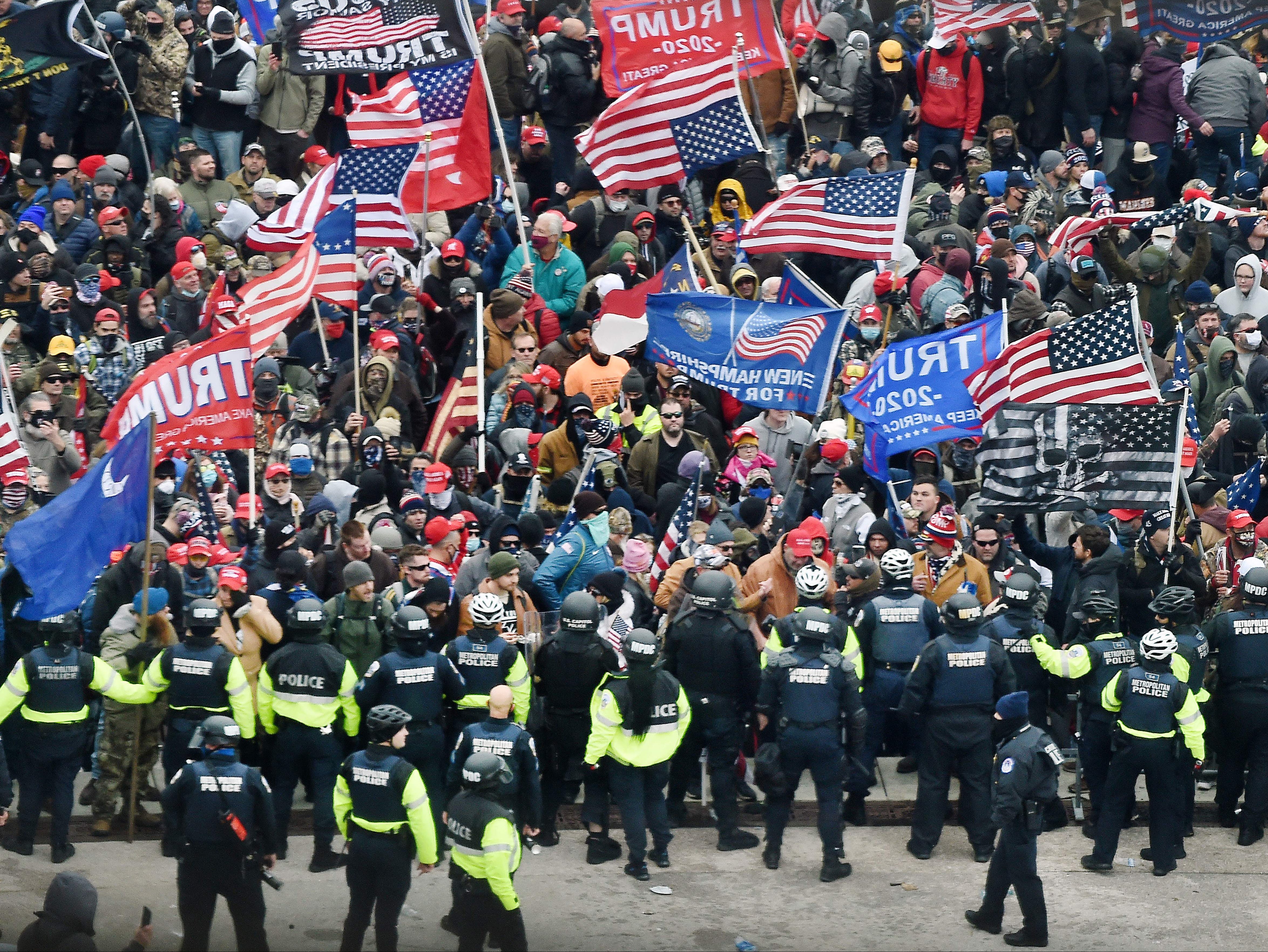 Trump supporters clash with police and security forces as they storm the US Capitol in Washington, DC on 6 January 2021