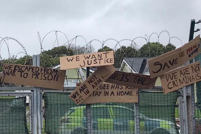 Protest signs put up by asylum seekers housed at the Penally military camp last month call for ‘justice’ and aid.