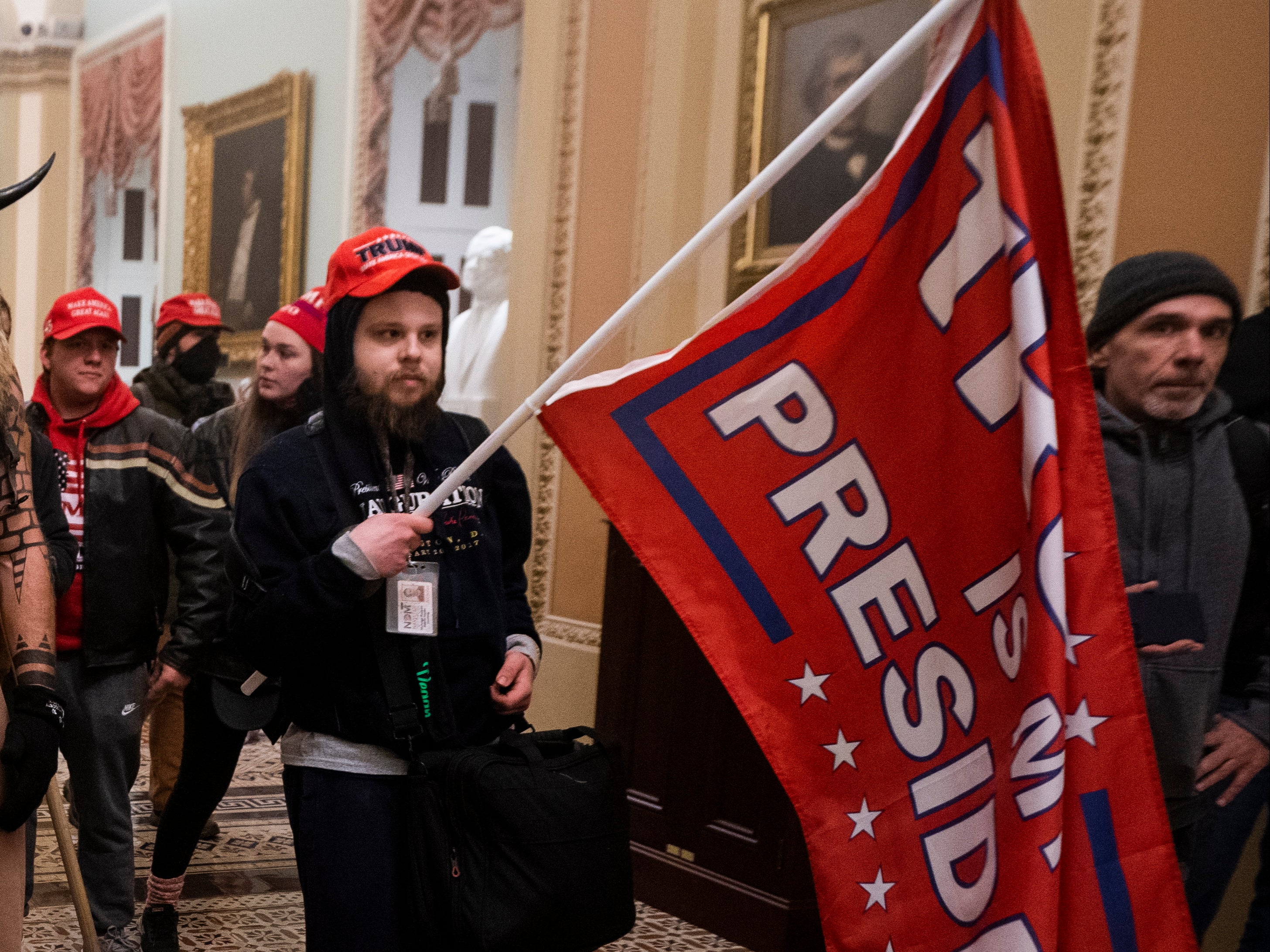 Supporters of US President Donald J. Trump stand by the door to the Senate chambers after they breached the US Capitol security in Washington, DC, USA, 06 January 2021. Protesters stormed the US Capitol where the Electoral College vote certification for President-elect Joe Biden took place. EPA/JIM LO SCALZO