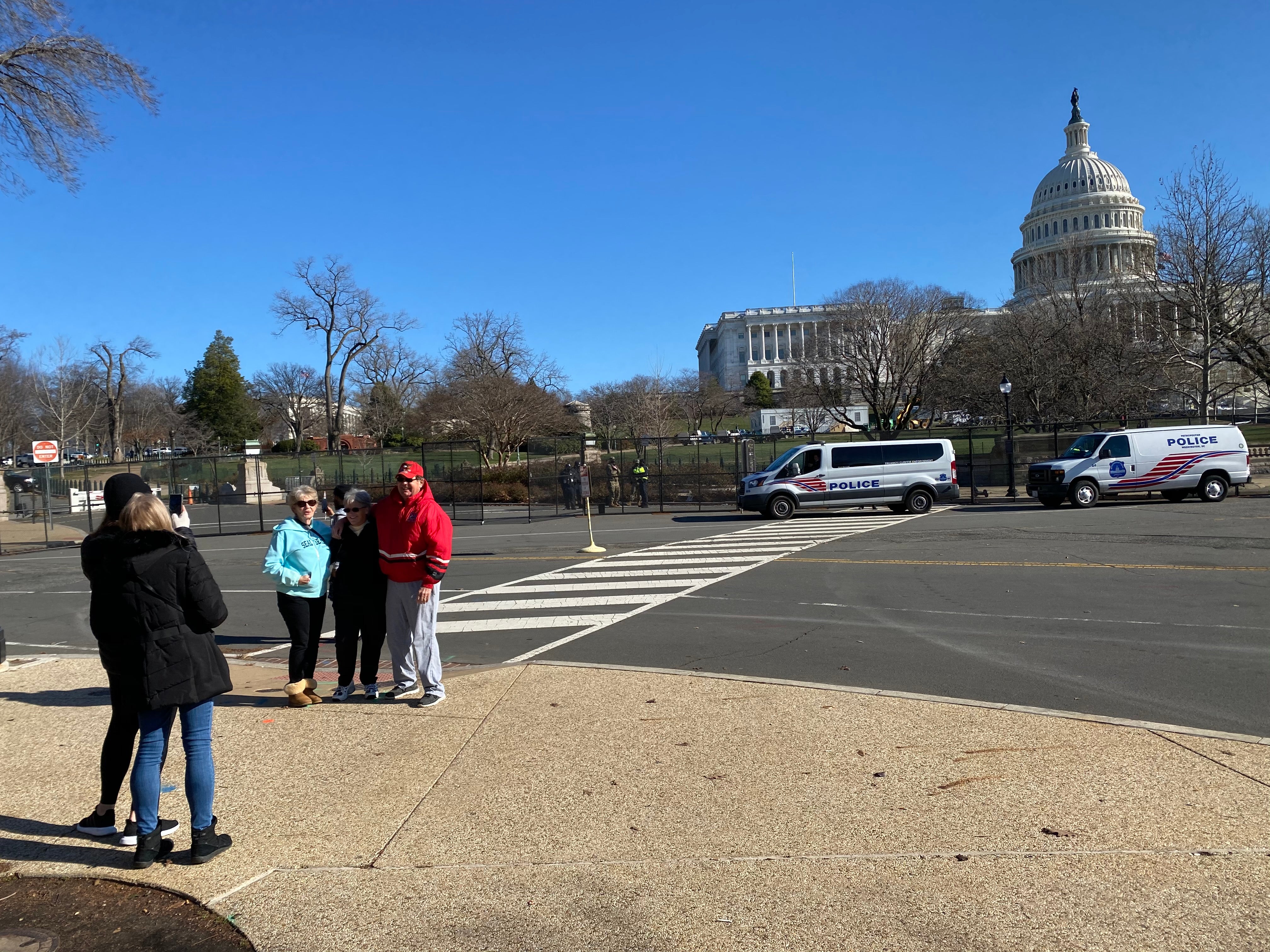 Trump supporters take their picture in front of the Capitol building a day after it was stormed.&nbsp;