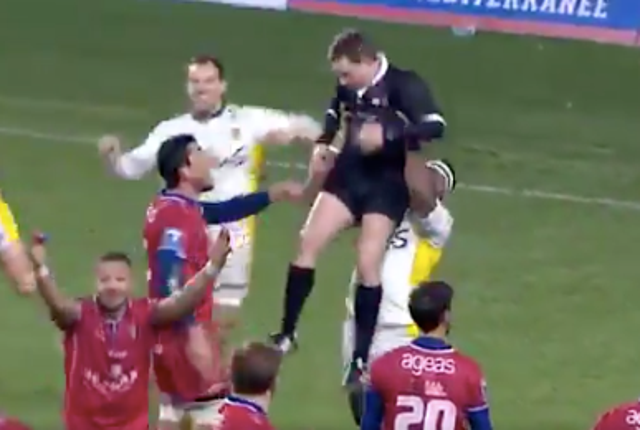 French rugby player Josaia Raisuqe lifts referee Laurent Millotte