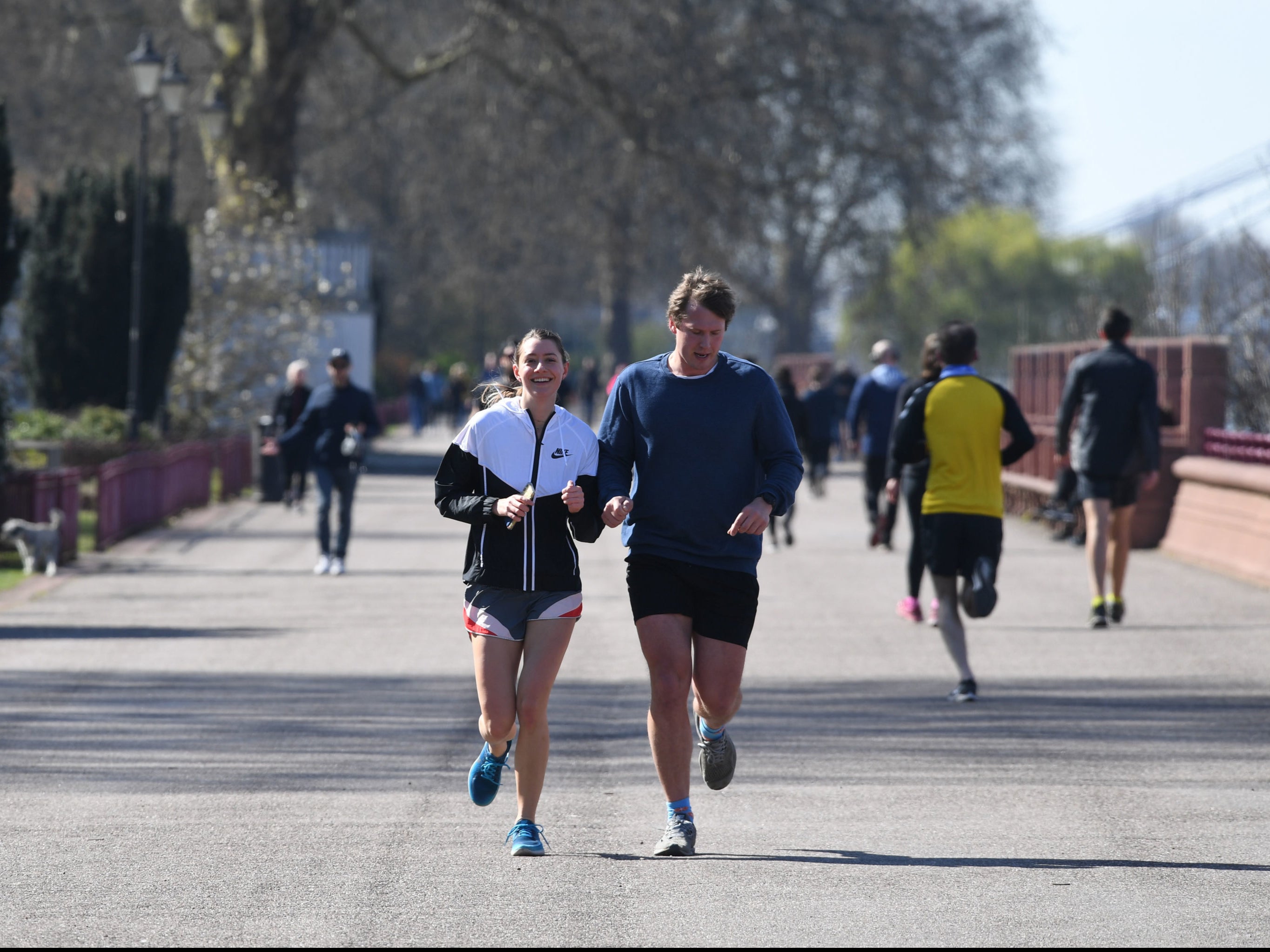 People jogging in Battersea Park, London