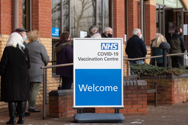 <p>People queue outside an NHS mass vaccination centre in Stevenage, one of several opening this week, to receive a Covid-19 jab</p>