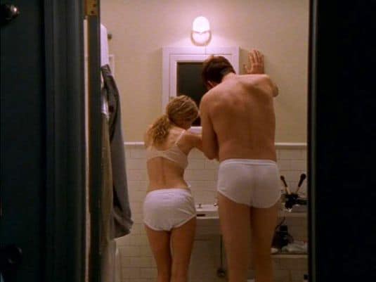 Carrie and Adrian cleaning their teeth in matching briefs