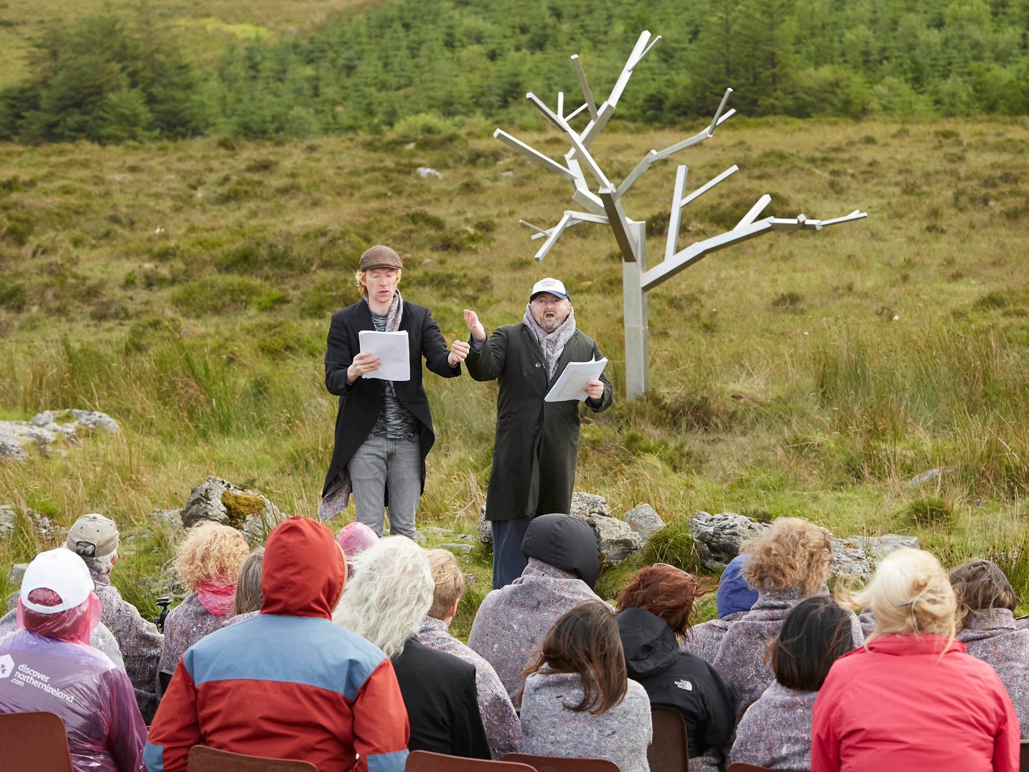 Actors Domhnall Gleeson (left) and David Pearse during a reading of Arts Over Borders’ ‘All Mankind Is Us: Walking for Waiting for Godot’ beside Sir Antony Gormley’s stainless steel ‘Tree for Waiting for Godot’, along the border between Fermanagh and Cavan