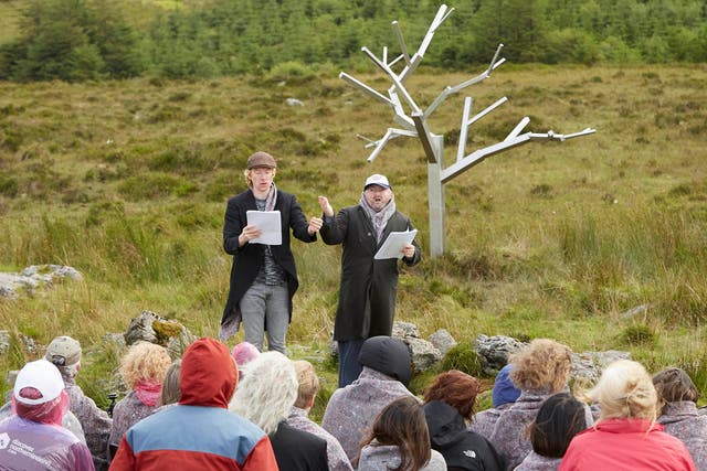 <p>Actors Domhnall Gleeson (left) and David Pearse during a reading of Arts Over Borders’ ‘All Mankind Is Us: Walking for Waiting for Godot’ beside Sir Antony Gormley’s stainless steel ‘Tree for Waiting for Godot’, along the border between Fermanagh and Cavan </p>