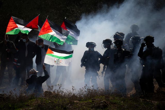 <p>Israeli border police officers and Palestinians clash during a protest against the expansion of Israeli Jewish settlements near the West Bank town of Salfit in December</p>