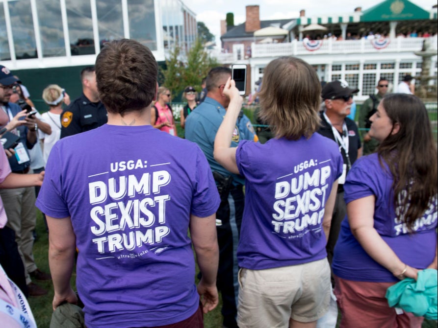 Protestors attend the US Women’s Open at Bedminster in 2017