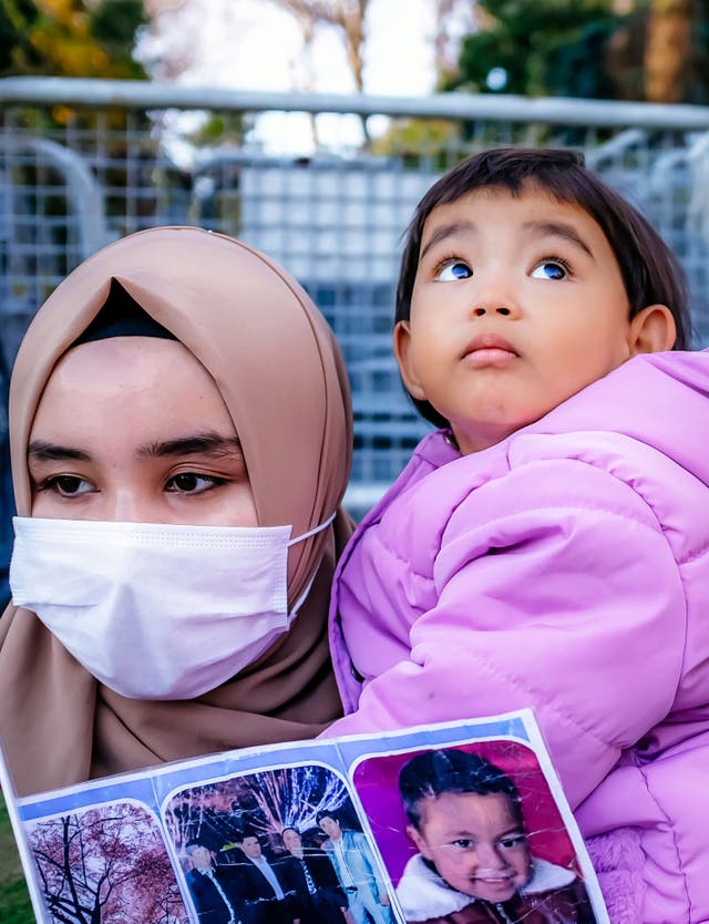 A member of the Muslim Uighur minority holds a child in her arms as she demonstrates in front of the Chinese consulate in Istanbul last month (Photo by BULENT KILIC/AFP via Getty Images)