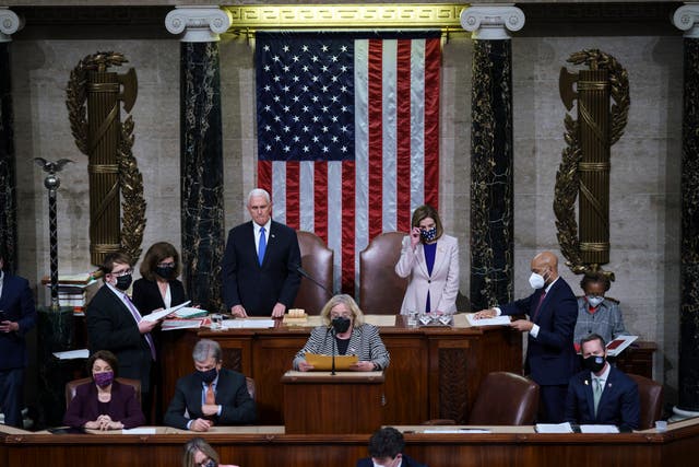 <p>Vice President Mike Pence and Speaker of the House Nancy Pelosi, D-Calif., prepare to read the final certification of Electoral College votes cast in November's presidential election during a joint session of Congress after working through the night, at the Capitol on 7 January 2021 in Washington, DC.</p>