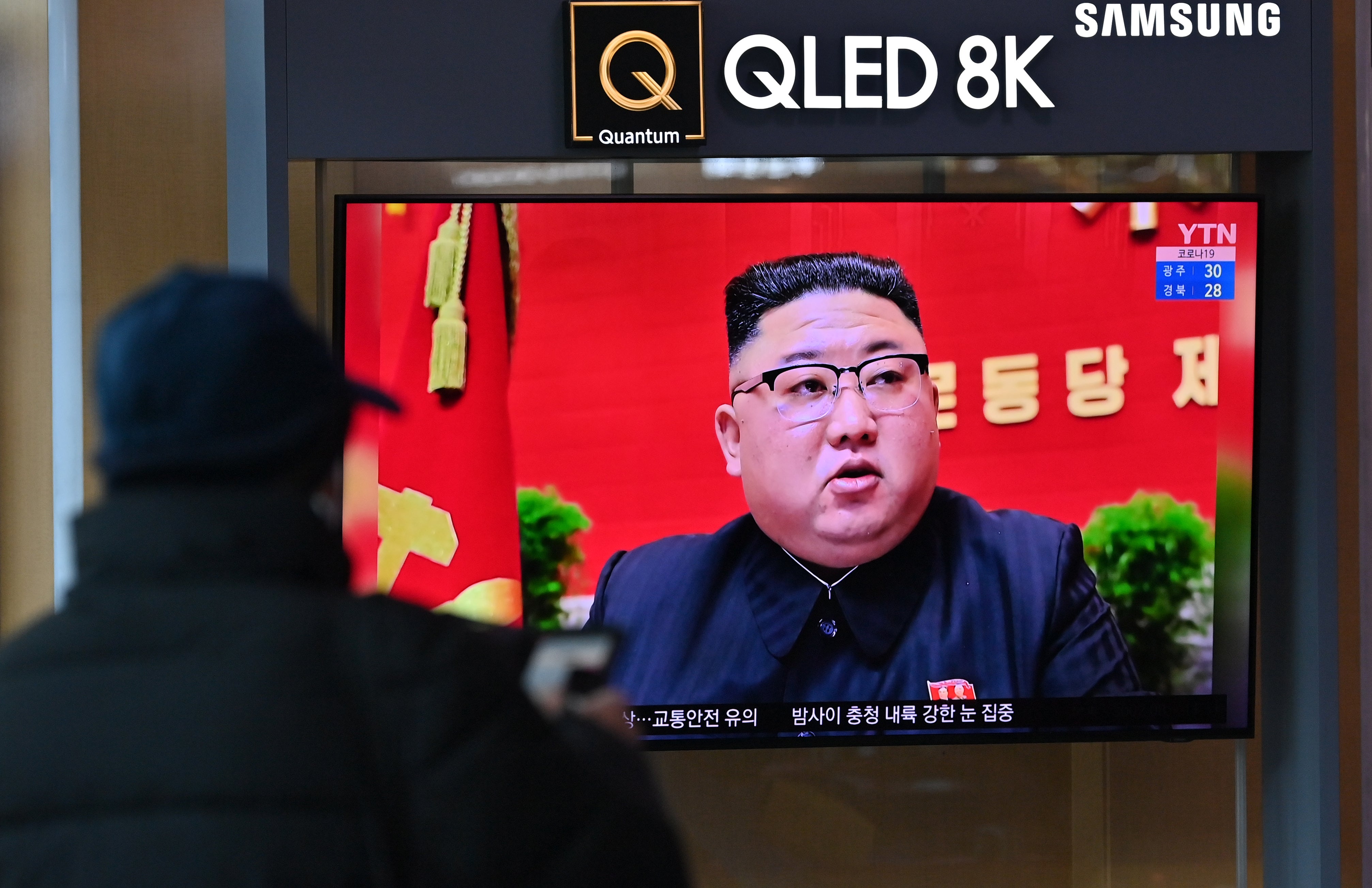 A man watches a television screen showing news footage of North Korean leader Kim Jong Un attending the 8th congress of the ruling Workers' Party held in Pyongyang, at a railway station in Seoul on 6 January 2021