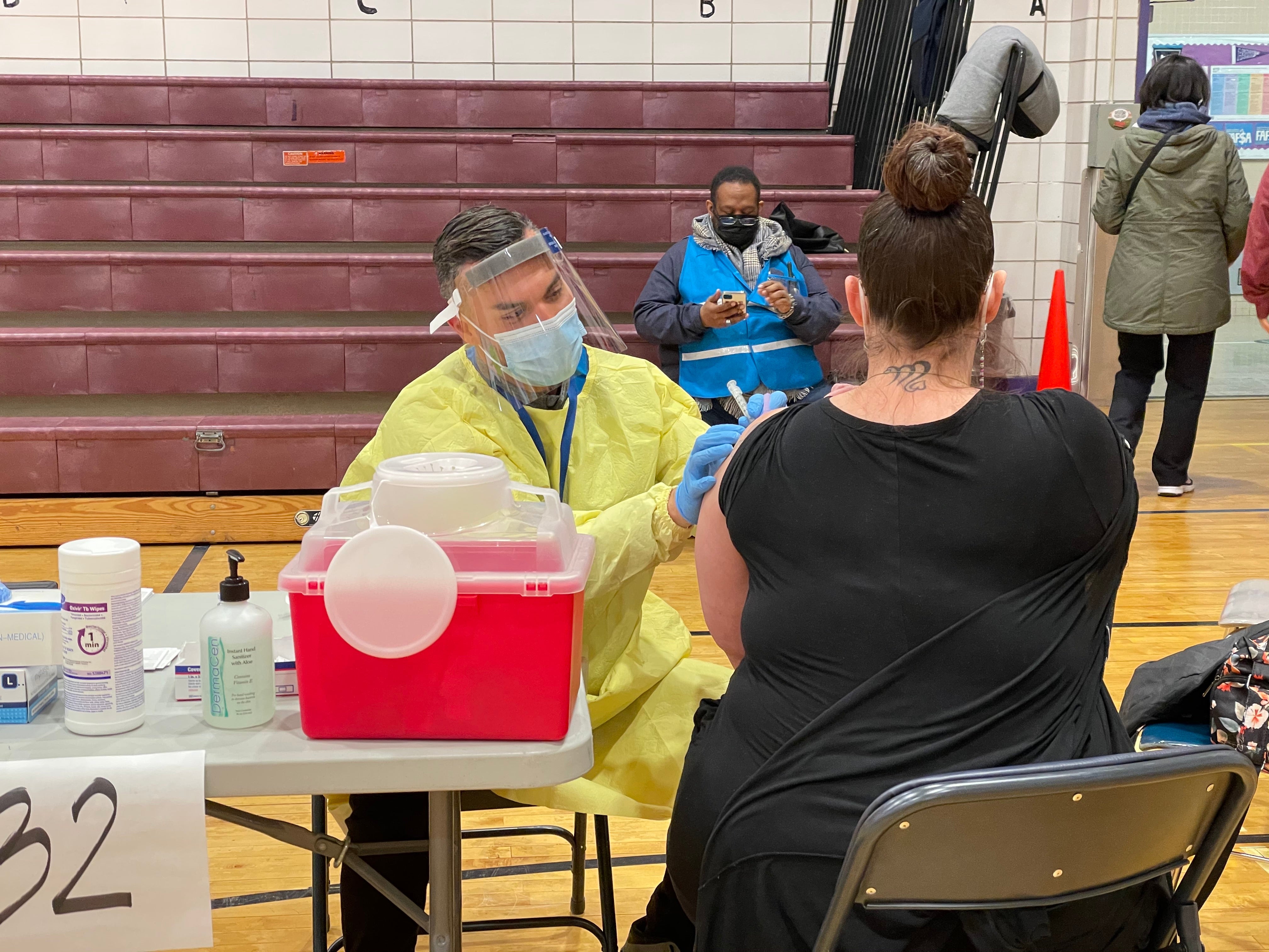 A New York teacher receives Moderna’s Covid-19 vaccine at one of New York City’s new vaccination hubs.