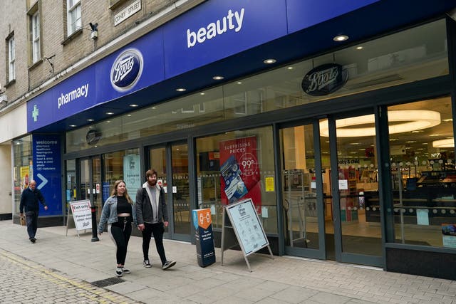 People walk by a Boots pharmacy on 09 July, 2020 in York, United Kingdom, wearing masks. A Boots location is set to be one of the first high street pharmacies to start rolling out coronavirus vaccines.