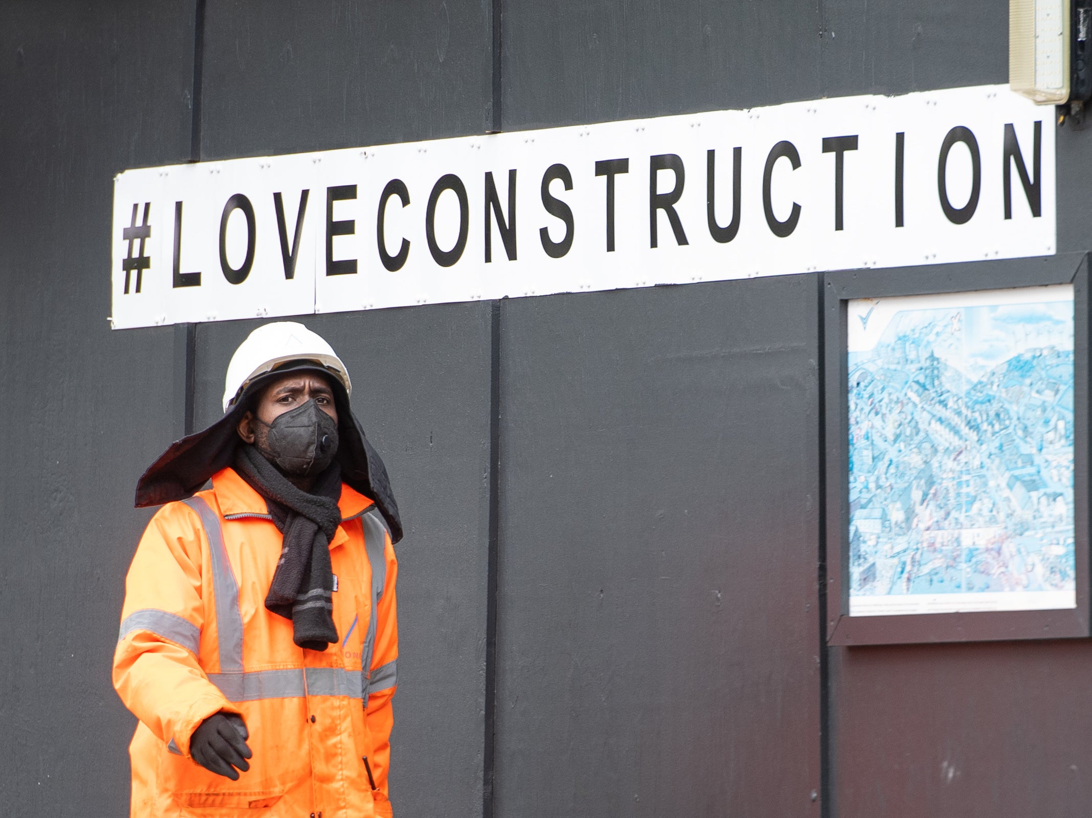 A construction worker wearing a protective face mask at a building site in central London, as Prime Minister Boris Johnson said people who cannot work from home should be "actively encouraged" to return to their jobs