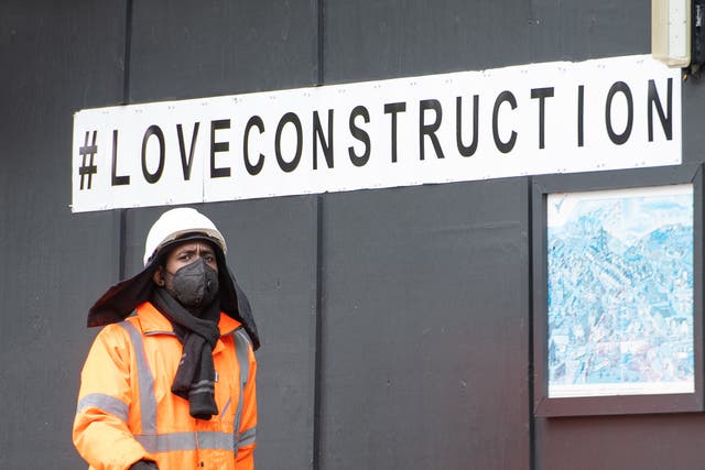 <p>A construction worker wearing a protective face mask at a building site in central London, as Prime Minister Boris Johnson said people who cannot work from home should be "actively encouraged" to return to their jobs</p>