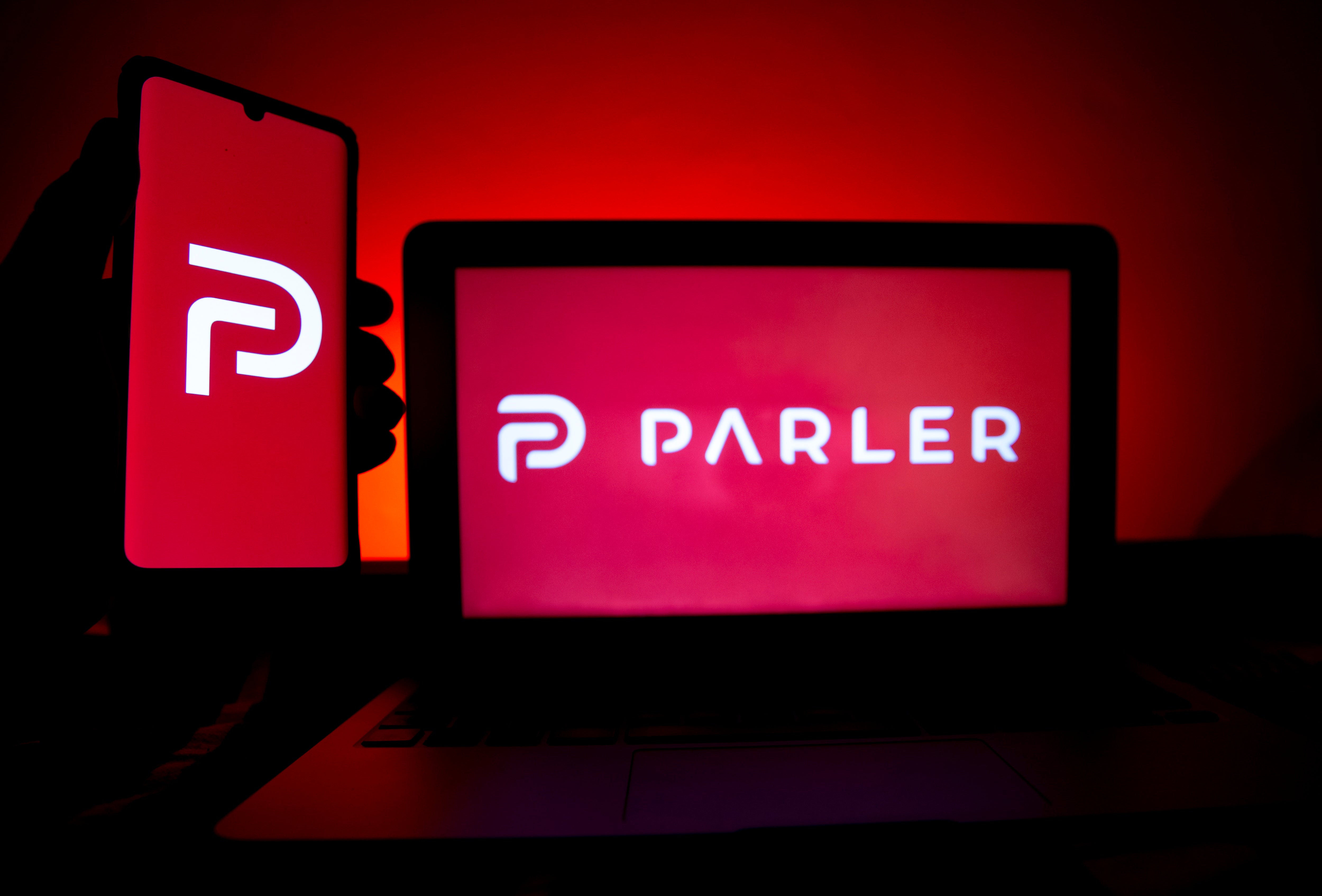 A photo illustration shows the logo of Conservative social media application (app) Parler on a computer and mobile telephone screen, in Paris, France, on 11 January 2021