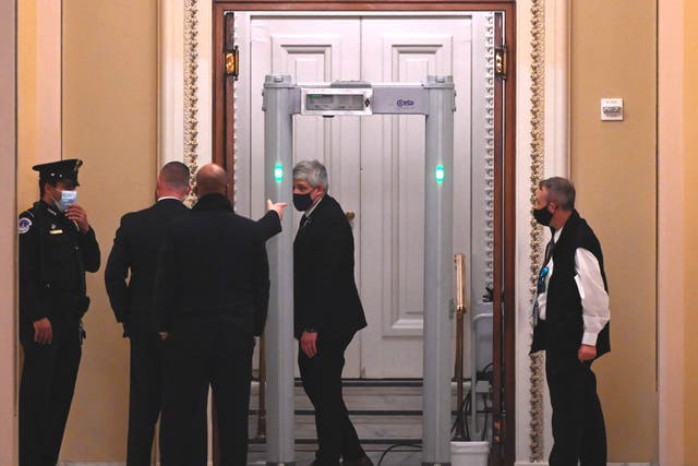 <p>US Capitol Police stand near a metal detector outside the House of Representatives Chamber, in Washington, DC</p>