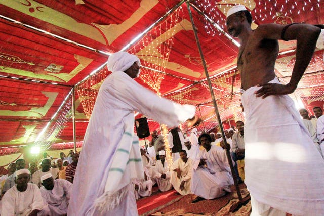 A man whips another during a traditional ceremony at a wedding 