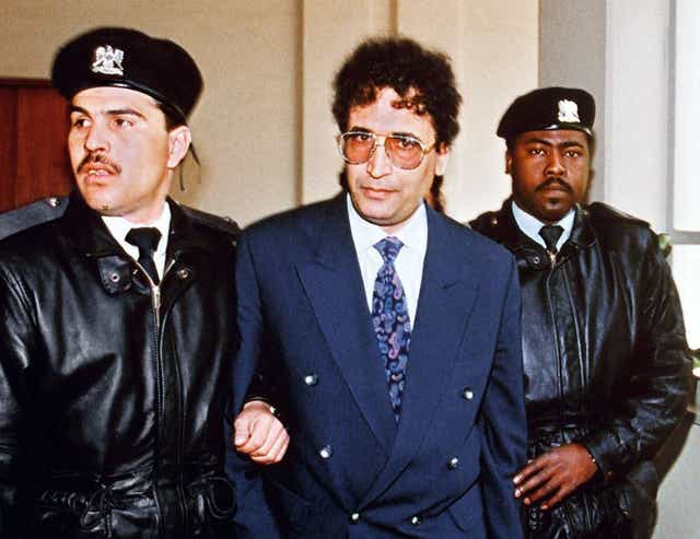 Abdelbaset Ali Mohmet al-Megrahi, later convicted of the Lockerbie bombing, is escorted by security officers on 18 February, 1992. 