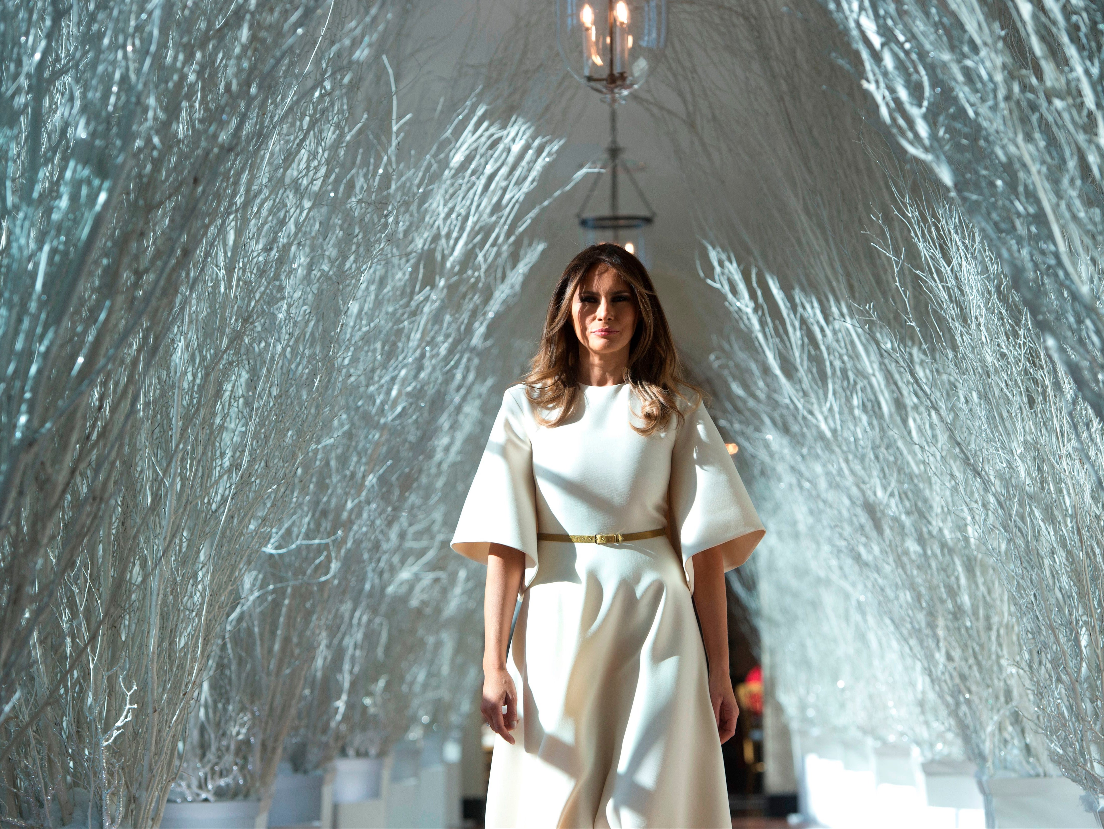 First Lady Melania Trump walks through Christmas decorations in the East Wing, 27 November 2017