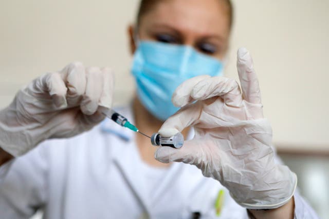 <p>A nurse prepares a dose of Pfizer-BioNTech Covid-19 vaccine&nbsp;</p>