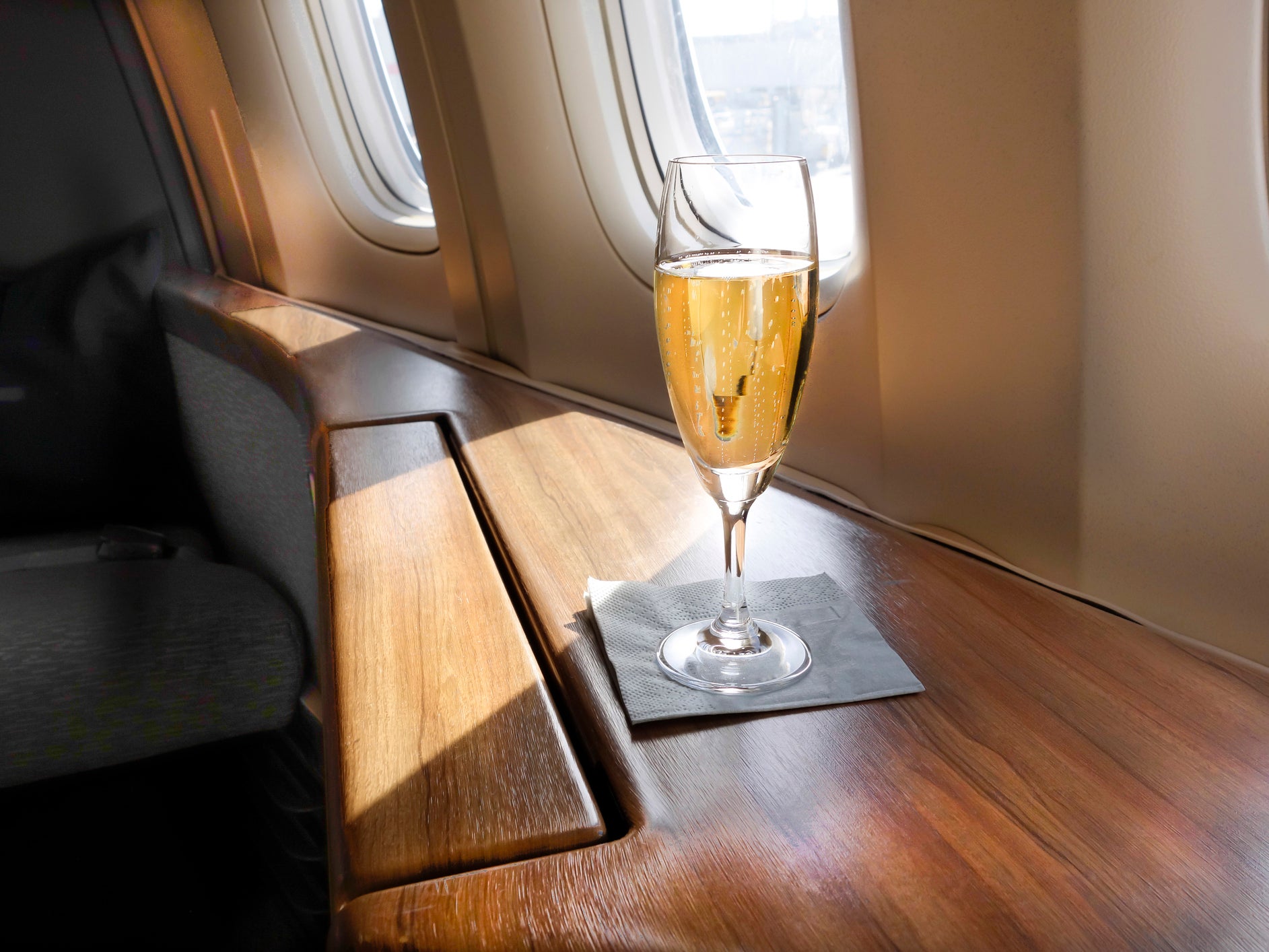 A glass of Champagne awaits a First Class passenger on an airline flight