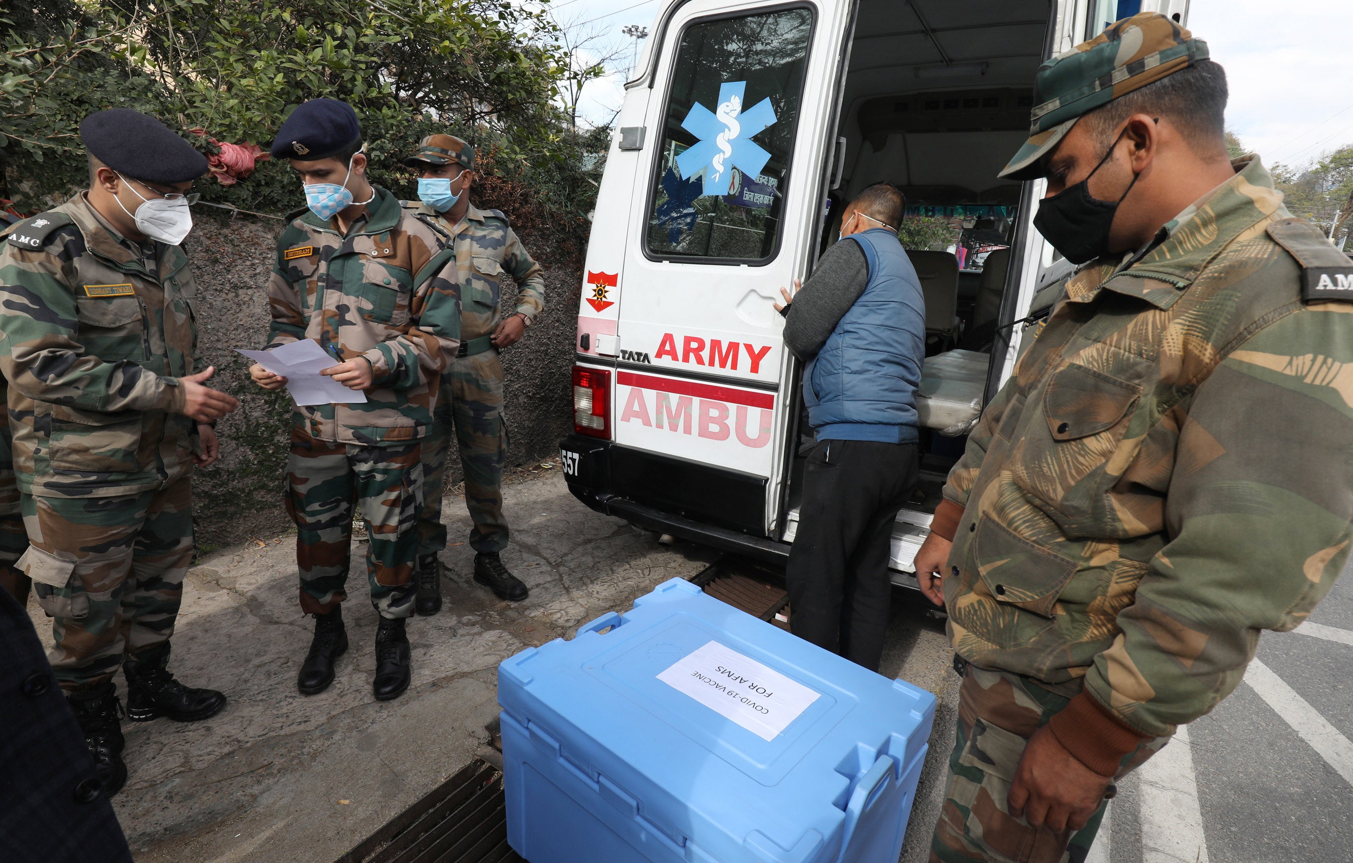 Indian army personnel assist in distributing the Covid-19 vaccines